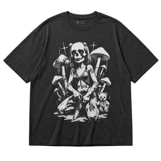 A black short-sleeve t-shirt with a detailed black and white graphic print of a skull-headed girl gripping a chainsaw surrounded by mushrooms and a teddy bear, shown flat against a white background.